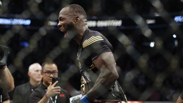 Leon Edwards celebrates in the cage