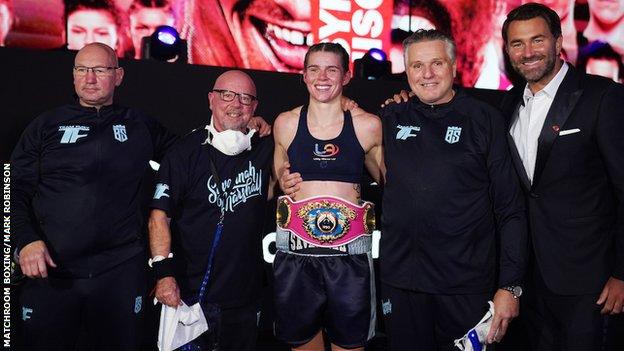 Marshall celebrates her world title win with her team