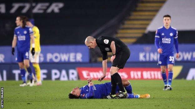 Injured James Justin lays on the pitch