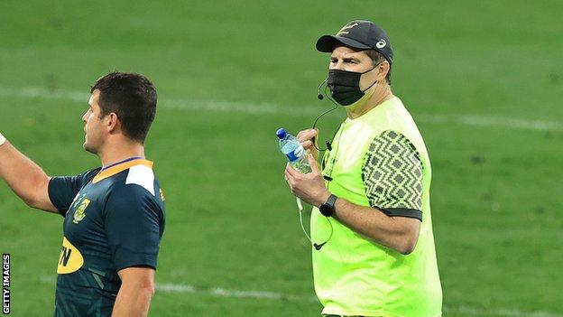 Rassie Erasmus brings on water for a South Africa player