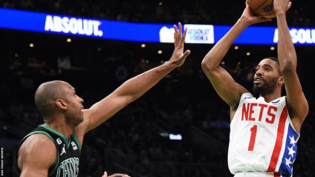 Mikal Bridges shoots the ball over Al Horford