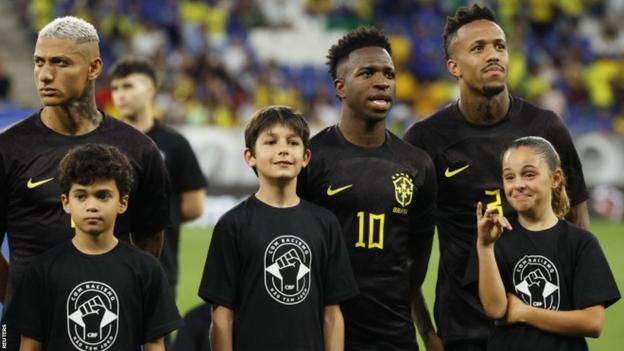 Vinicius Jr with mascots before Brazil's friendly with Guinea