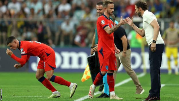 England boss Gareth Southgate shakes hands with James Maddison
