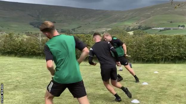 Northwich Victoria players training in the garden of manager Steve Wilkes' house