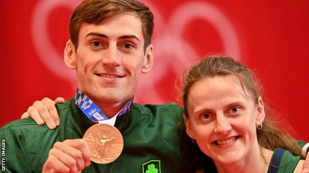 Aidan Walsh celebrates with his sister Mikaela on the podium with his Olympic bronze medal in the men's welterweight at the 2020 Tokyo Olympics
