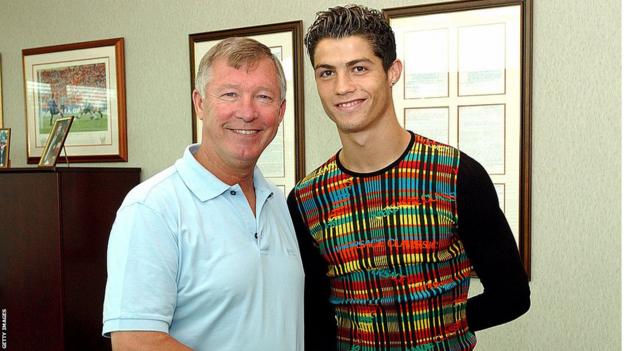 Cristiano Ronaldo stands next to Sir Alex Ferguson