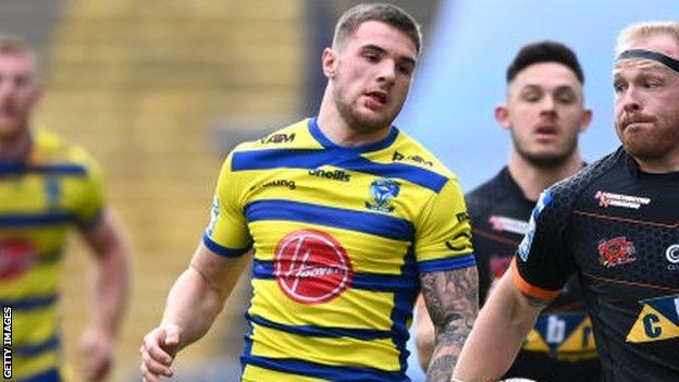 Connor Wrench (centre) in action for Warrington