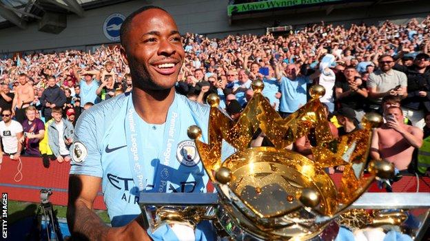 Raheem Sterling with the Premier League trophy after Manchester City's title win in 2018-19