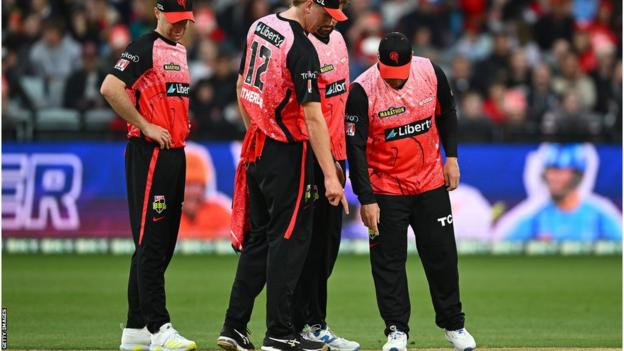 Melbourne Renegades players examine the pitch against Perth Scorchers
