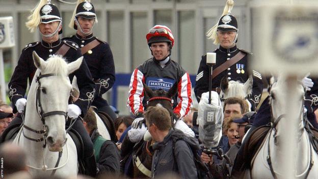 Graham Lee is led to the winner's circle on Amberleigh House after winning the Grand National at Aintree racecourse
