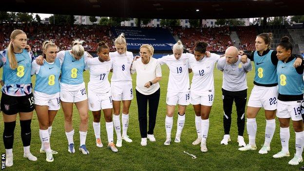 England gather in a huddle after beating Switzerland