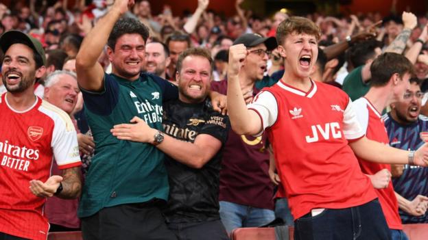 Arsenal fans celebrate as their side beat Manchester City