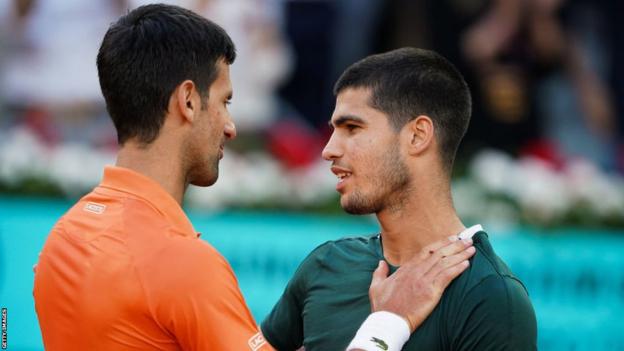 Novak Djokovic and Carlos Alcaraz embrace after the Madrid Open 2022 semi-final