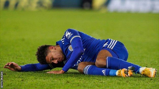 Leicester full-back James Justin lies injured on the pitch