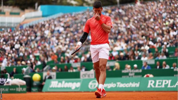 Novak Djokovic looks frustrated in his match with Lorenzo Musetti
