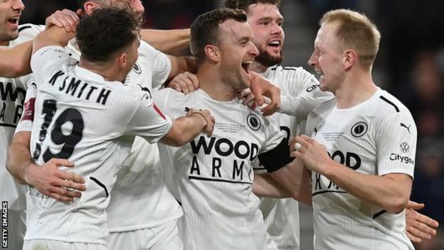 Boreham Wood's players celebrate scoring against Bournemouth in the FA Cup