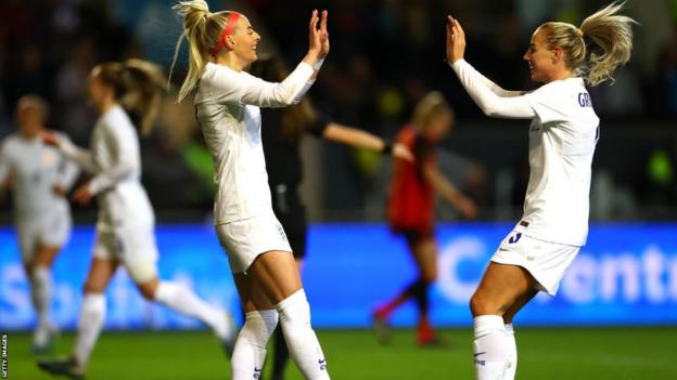 Chloe Kelly and Alex Greenwood celebrate England's third goal against Belgium