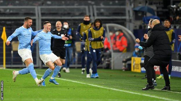 Phil Foden (second from left) celebrates his goal with manager Pep Guardiola (right)