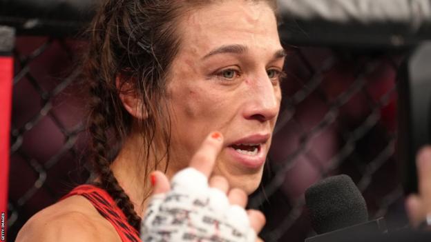 Joanna Jedrzejczyk speaks on a mic after a fight