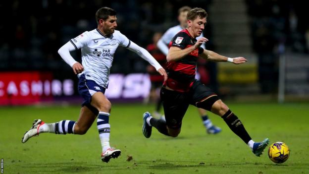 Preston North end striker Ched Evans (left) pressures QPR defender Jimmy Dunne at Deepdale