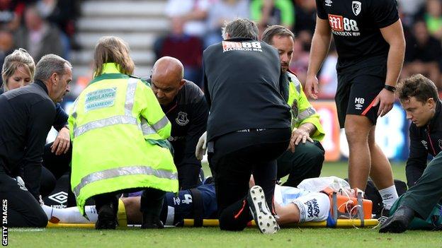 Michael Keane receives treatment on the pitch