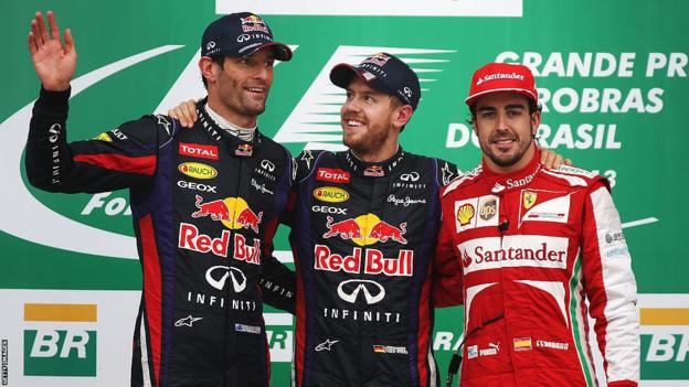 Race winner Sebastian Vettel of Red Bull Racing celebrates on the podium with second placed Mark Webber of Red Bull Racing and third placed Fernando Alonso of Ferrari following the Brazilian Grand Prix in 2013