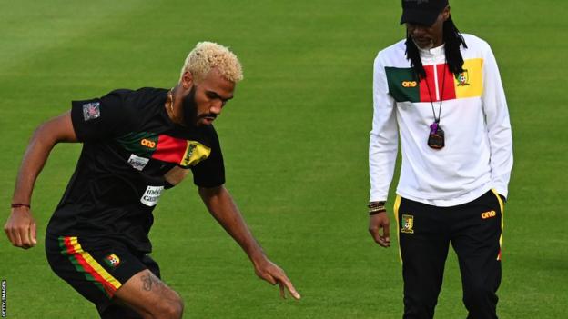 Eric Maxim Choupo-Moting of Cameroon in training, watched by coach Rigobert Song