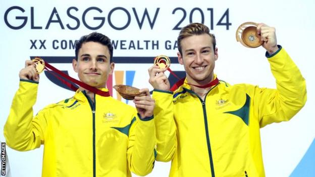 Australian divers Domonic Bedggood (left) and Matthew Mitcham (right) on the podium holding up their medals at the 2014 Glasgow Commonwealth Games