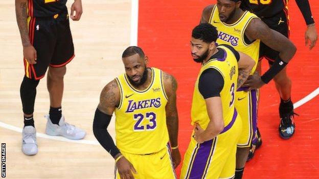 LeBron James, stood alongside Anthony Davis, involved in an argument with a fan