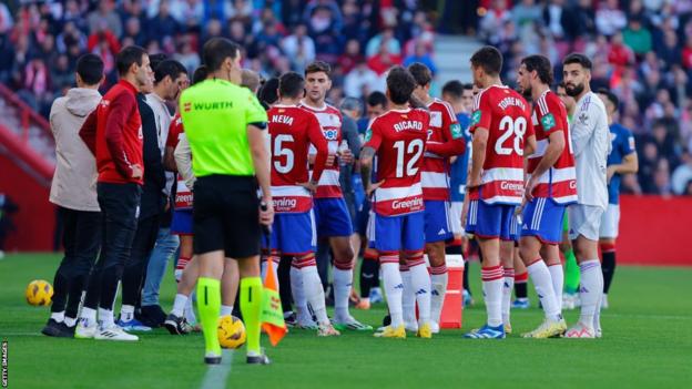Granada and Athletic Bilbao players walk off the pitch