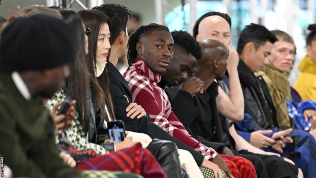 Bukayo Saka, Eberechi Eze and Son Heung-Min on the front row waiting for the show to start