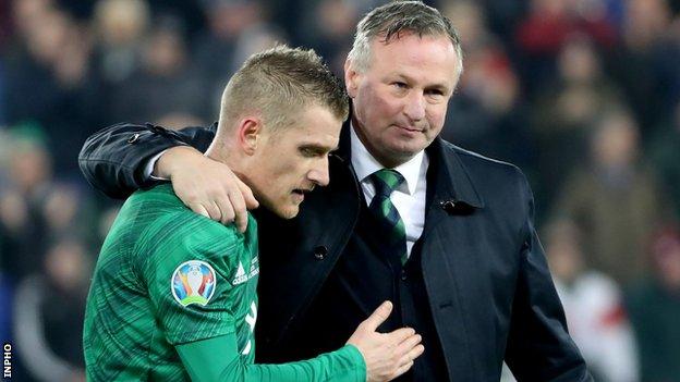 Michael O'Neill consoles Steven Davis at the final whistle on Saturday after the Northern Ireland captain's earlier penalty miss against the Dutch