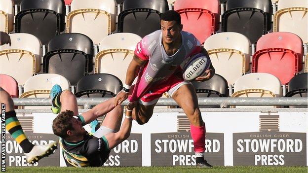 Dragons wing Ashton Hewitt on his way to scoring one of his tries against Northampton