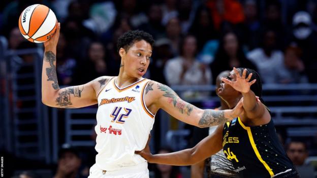 Brittney Griner of the Phoenix Mercury controls the ball and holds off Joyner Holmes