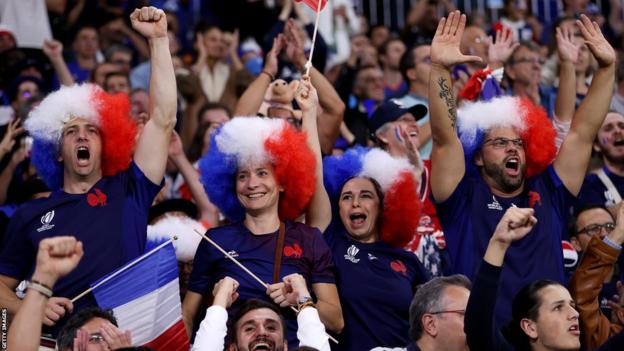 France fans celebrate their team beating Italy