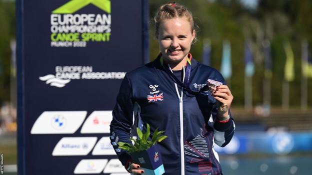 Hope Gordon holds up a bronze medal at the European Championships in 2022