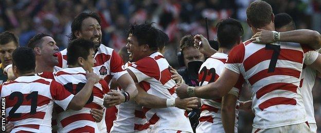 Japan's players celebrate after causing possibly the greatest upset at a Rugby World Cup as they beat two-time tournament winners South Africa.