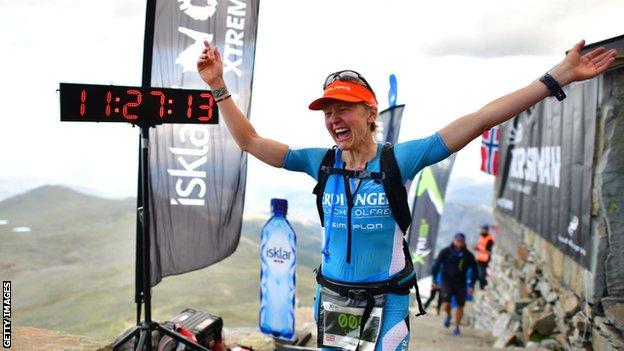 Lucy Gossage celebrates after winning the Norseman Xtreme Triathlon