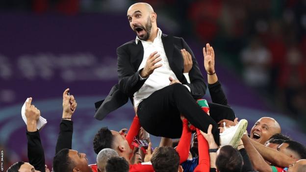 Walid Regragui, Head Coach of Morocco, celebrates with the team after the 1-0 win during the FIFA World Cup Qatar 2022 quarter final match between Morocco and Portugal at Al Thumama Stadium on December 10, 2022 in Doha, Qatar.
