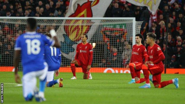 Liverpool and Everton players take a knee