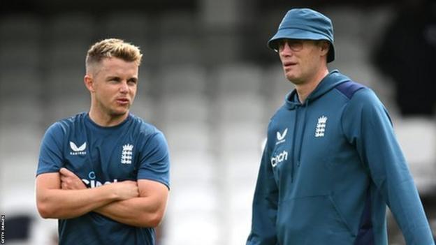 Andrew Flintoff (right) chatting with England all-rounder Sam Curran