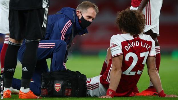 Arsenal's David Luiz is treated for an injury against Leicester
