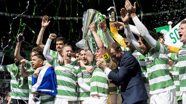 Celtic players celebrating with the Scottish Premirship trophy