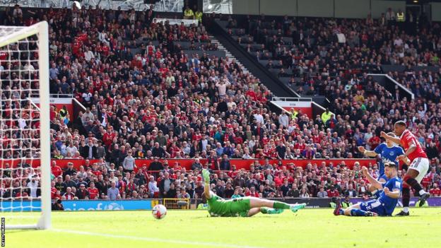 Manchester United striker Anthony Martial scores against Everton in the Premier League