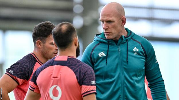 Paul O'Connell speaks with a couple of Ireland players during a training session