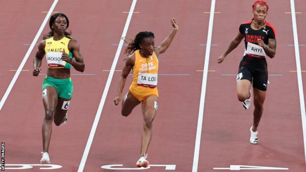 Ivory Coast's Marie-Josee Ta Lou (centre) wins her 100m semi-final at the Tokyo Olympics