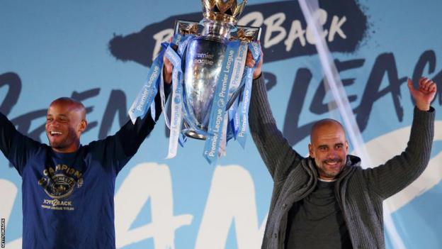 Vincent Kompany and Pep Guardiola lift the Premier League trophy in 2019