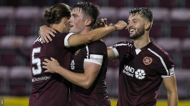 John Souttar (centre) celebrates at full-time with his Hearts team-mates