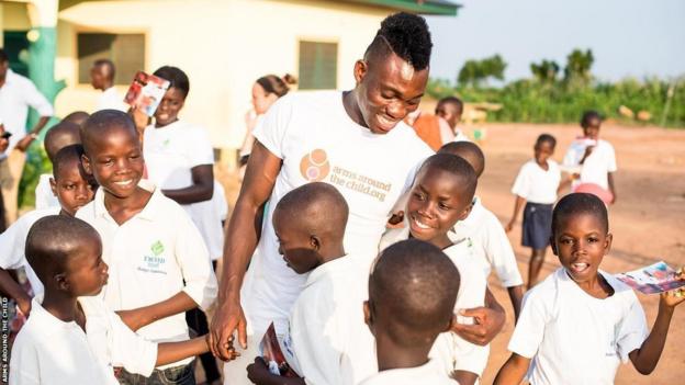 Christian Atsu playing with children outdoor at the Becky's Foundation