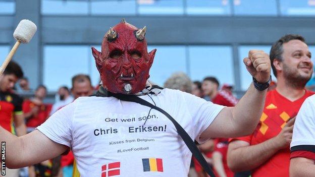 Belgium fan wears a shirt in tribute to Eriksen